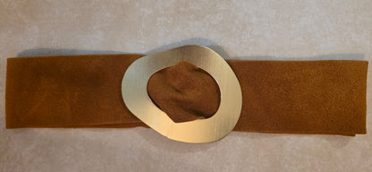 camel belt with a large gold buckle